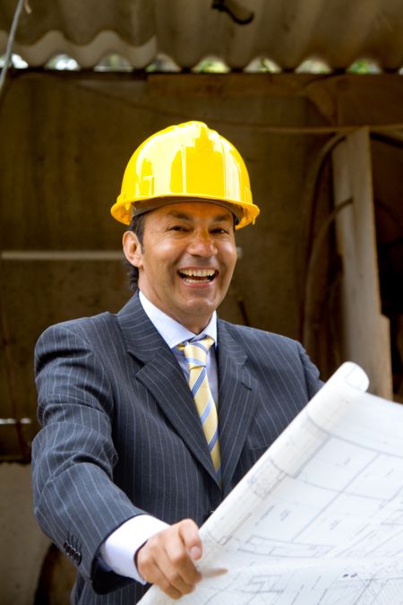 Elegant engineer holding a model in a construction