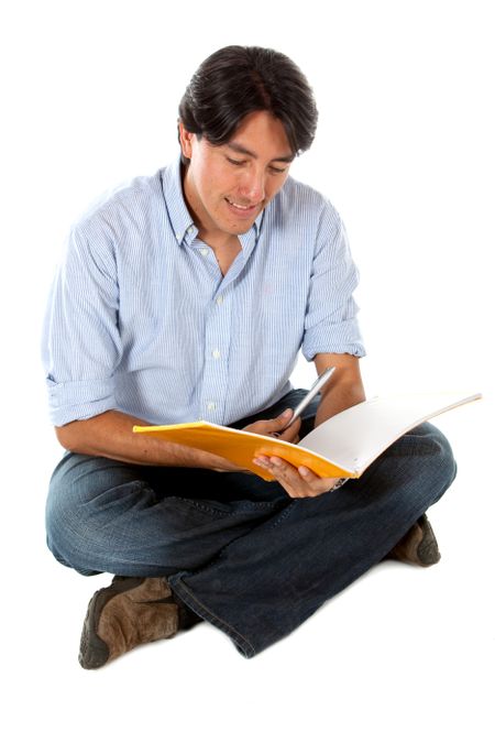 Man sitting on the floor studying isolated over a white background
