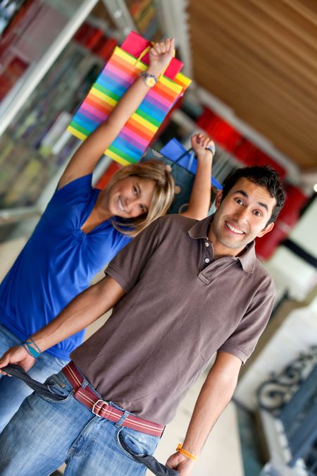 Shopping man with empty pockets and his girlfriend behind