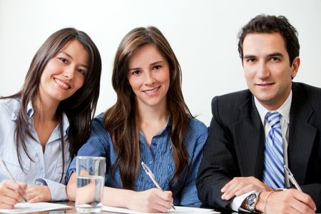 Group of young business people at the office smiling