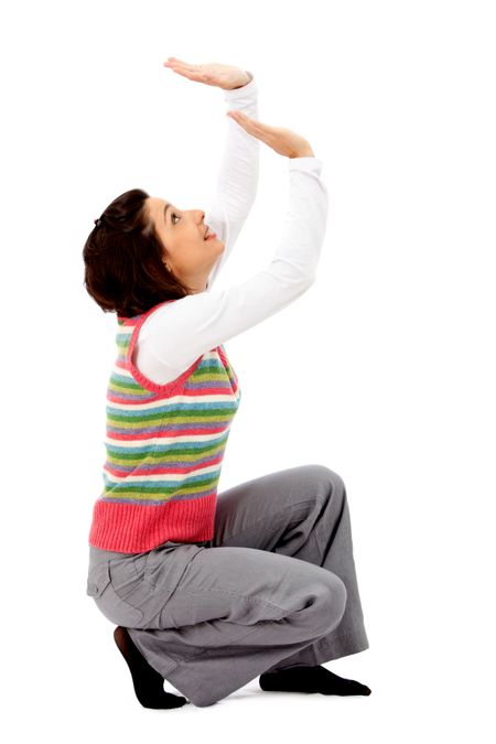 Woman holding up an imaginary object isolated over a white abckground