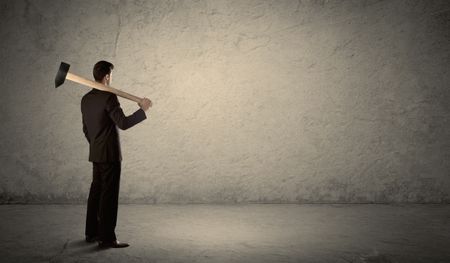 A businessman in modern stylish elegant suit standing on a small ladder and drawing pie and block charts on grey wall background with exponential progressing curves, lines, circles, blocks, numbers