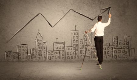 A businessman in modern stylish elegant suit standing on a small ladder and drawing pie and block charts on grey wall background with exponential progressing curves, lines, circles, blocks, numbers