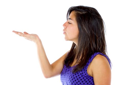 casual woman blowing something on her hand isolated over a white background
