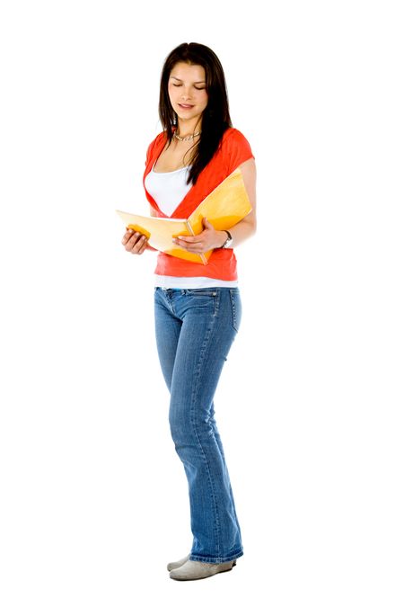 Beautiful female student standing with a notebook over a white background