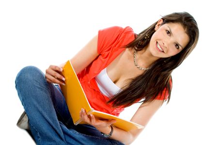 Beautiful female student with a notebook isolated over a white background