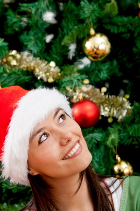 Pensive Christmas woman portrait with a Santa hat
