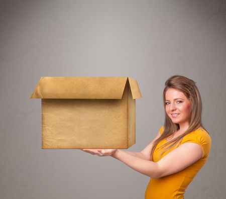 Beautiful young woman holding an empty cardboard box