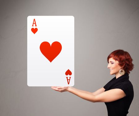 Beautifu young woman holding a red heart ace