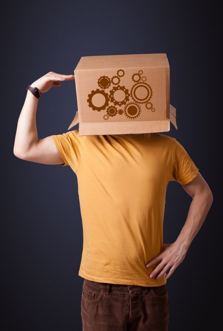 Young man standing and gesturing with a cardboard box on his head with spur wheels