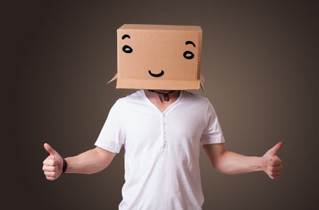 young-man-standing-gesturing-cardboard-box-481485085 Young man standing and gesturing with a cardboard box on his head with smiley face