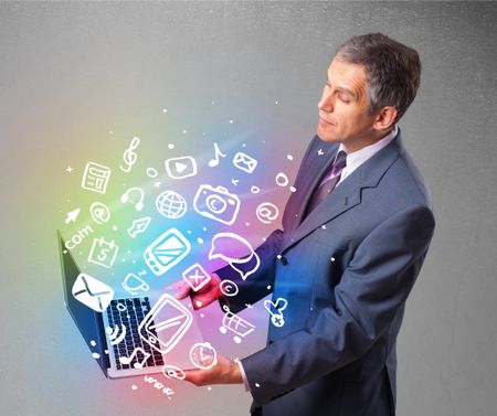 Middle aged businessman holding notebook with colorful hand drawn multimedia icons 