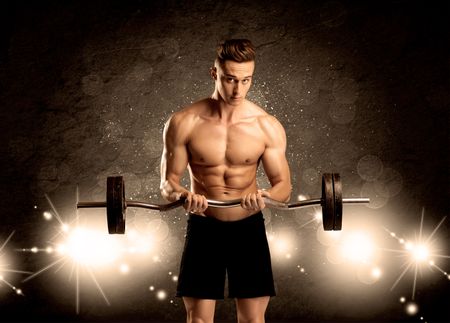 An attractive muscular guy working out with weights and showing naked upper body with illustrated lights and bokeh concept