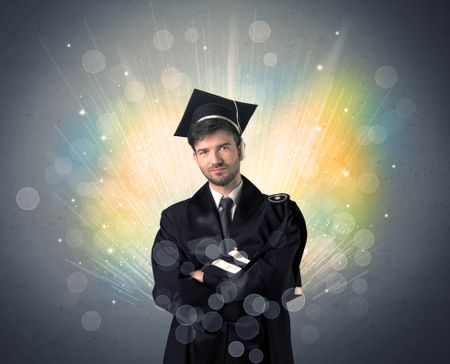 Happy graduate with colorful bokeg lights in the background grunge wall