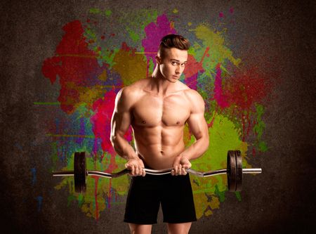 muscular-young-bodybuilder-lifting-weight-showing-481507057 A muscular young bodybuilder lifting weight and showing his hot body with muscles in front of an urban painted wall concept
