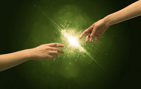 two-naked-male-hands-touch-lighting-481513168 Two naked male hands about to touch, lighting the spark with modest explosion in front of green background concept