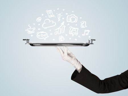 A professional waiter holding a silver plate with drawn communication, business and online media icons in front of a light blue background