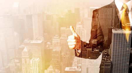 Business man looking at warm overlay city background