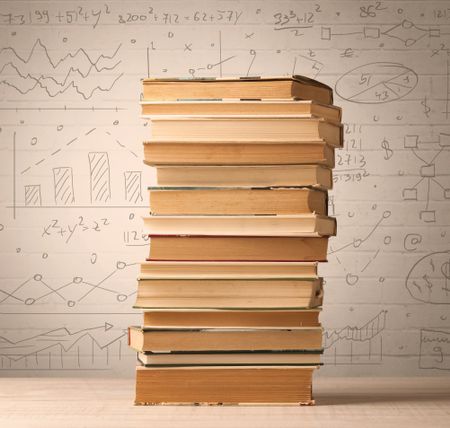 A pile of books with math formulas written in doodle style on background