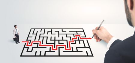 Business man looking at hand drawing solution, maze solution concept