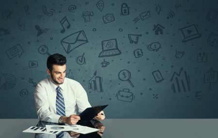 successful-businessman-kind-media-icons-background-481518583 Successful businessman with all kind of media icons in background