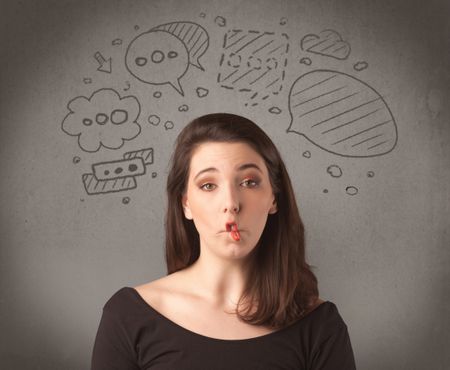 cute-female-student-making-funny-expressions-481526317 A cute female student making funny expressions with thoughts in her head illustrated by drawn chat bubbles on the urban wall background concept.