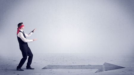 A confused blind salesman standing in front of a drawn arrow on the floor pointing in the right direction concept.