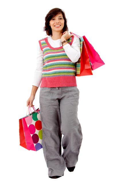 happy woman smiling with shopping bags isolated over a white background