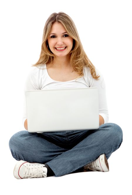 Casual girl on a laptop working on the floor over a white background