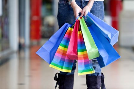 woman holding some shopping bags in a mall