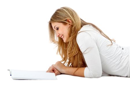 casual girl studying on the floor isolated over a white background