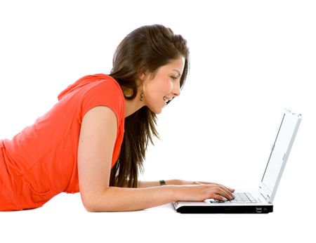 Casual girl on a laptop working on the floor over a white background