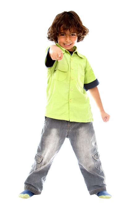 Casual boy pointing at you over a white background