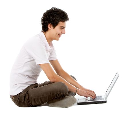 Casual man on a laptop computer working on the floor over a white background