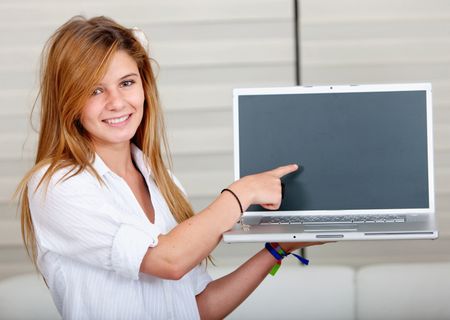 Casual girl smiling and displaying a laptop computer