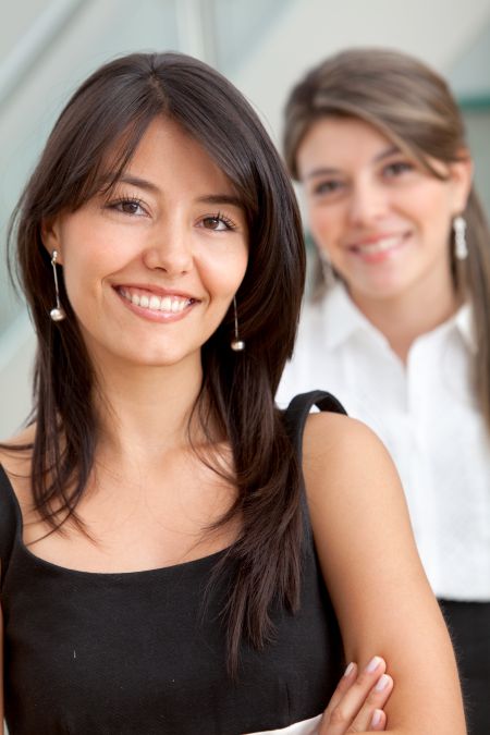 Friendly business women portrait smiling in the office