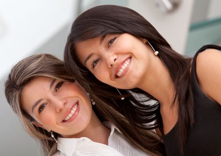 Friendly business women portrait smiling in the office