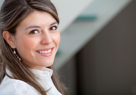 Friendly business woman portrait smiling in her office