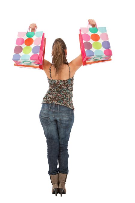 Rear view of a fashion woman with shopping bags isolated over a white background
