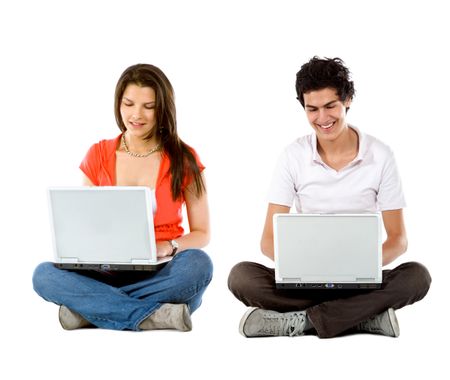 Young people sitting with laptop computers - isolated over white