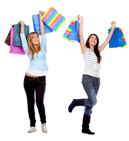 Happy shopping women with bags isolated over a white background