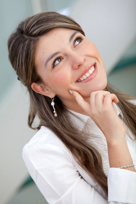 Thoughtful business woman smiling at the office