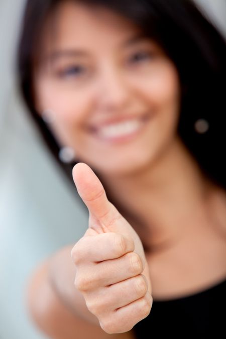 Business woman with thumbs up and smiling