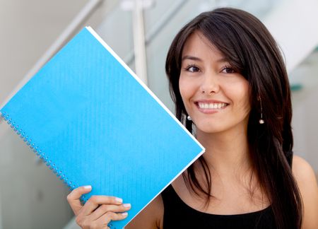 Beautiful business woman with a notebook and smiling