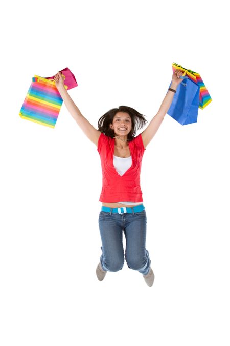 happy woman smiling and jumping with shopping bags isolated over a white background