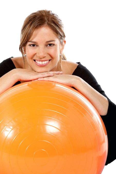 Beautiful woman with a pilates ball isolated over a white background