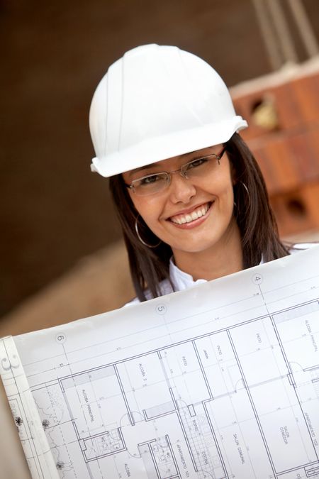 Elegant engineer holding a model in a construction