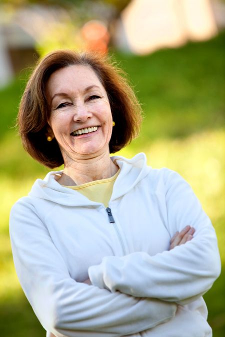 Happy woman in sportswear outdoors and smiling