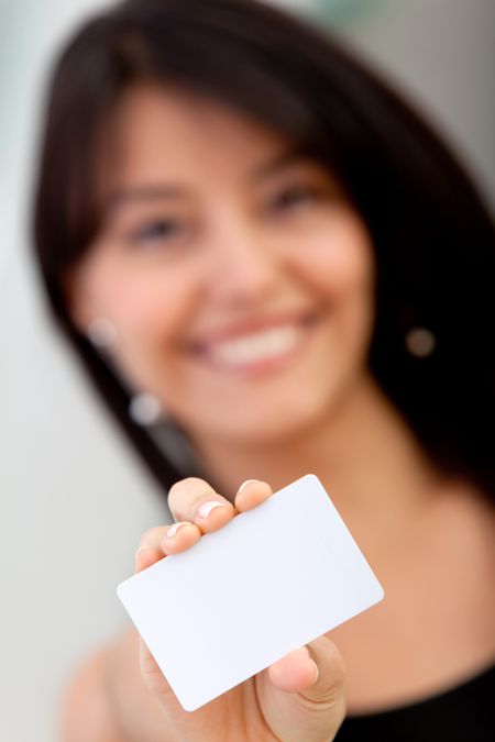Woman portrait displaying a business card smiling