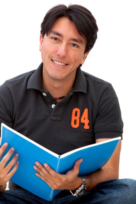 Male student sitting with a notebook - isolated over a white background